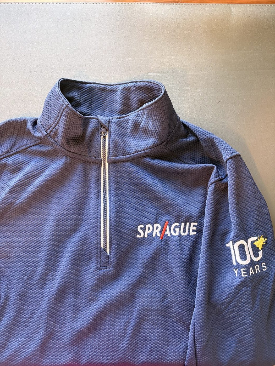 Anniversary-branded quarter-zip swag drop